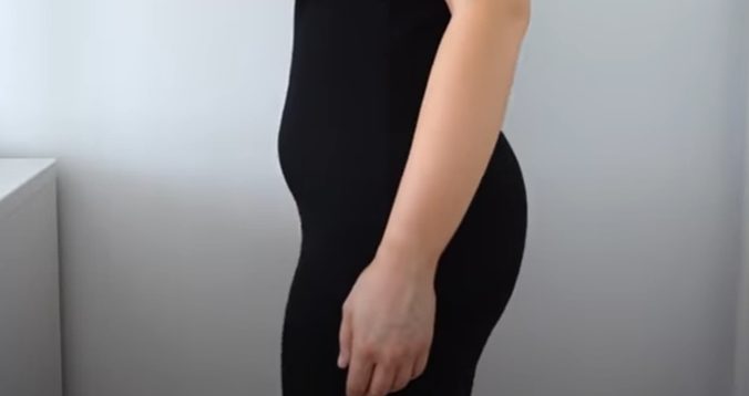 woman's fupa showing when wearing black bodycon