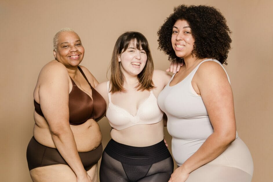 3 plus size woman wearing shaper wear posing for the camera
