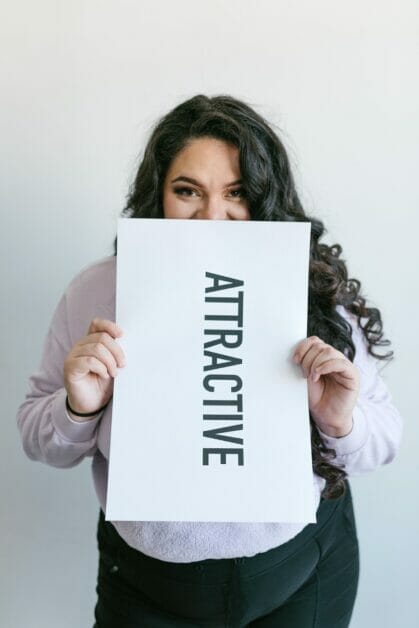 a woman holding an "articulate" word placard