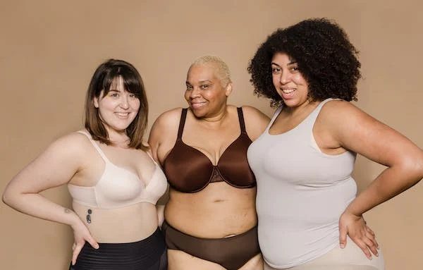 three women in shapewears posing for the camera