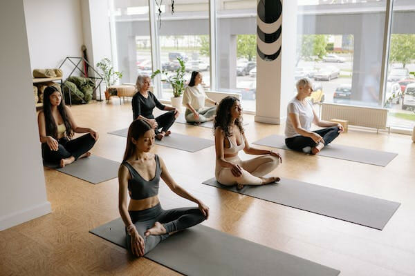 women in an indoor yoga session