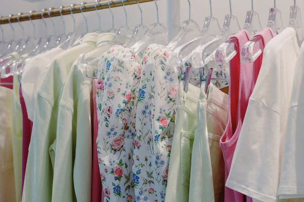 a dress/blouses hang on a rack