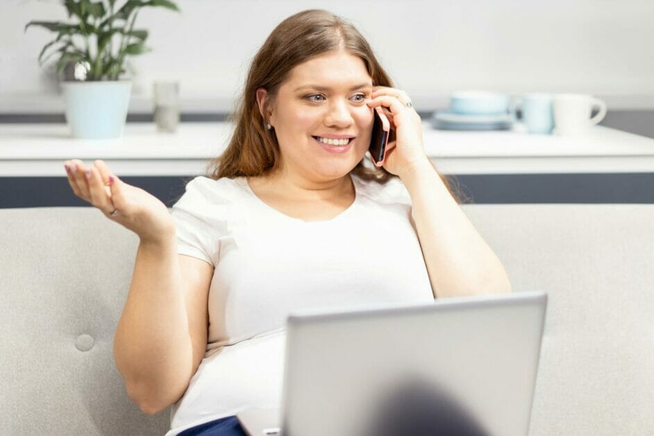 woman smiling while talking to someone on the phone